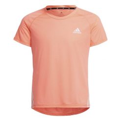 Koszulka z krótkim rękawem dla dzieci Adidas Aeroready Three Stripes Łosoś. Białe bluzki dla dziewczynek Adidas, bez wzorów, bez kołnierzyka, bez ramiączek. Za 71.00 zł.