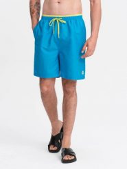 Spodenki męskie kąpielówki z dwukolorowym ściągaczem – niebieskie V6. Niebieskie kąpielówki męskie Ombre Clothing, l, bez wzorów, z poliesteru, do pływania. W wyprzedaży za 59.99 zł.