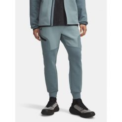 Spodnie Dresowe Męskie Under Armour. Niebieskie buty sportowe męskie Under Armour, m, bez wzorów, z dresówki, na fitness i siłownię. Za 199.99 zł.