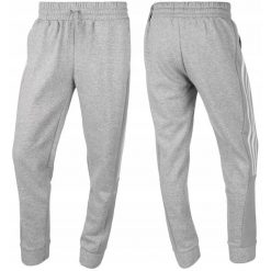 Damskie spodnie dresowe adidas Essentials Colorblock 3-Stripes. Białe spodnie dresowe damskie Adidas, bez wzorów, z bawełny. Za 129.99 zł.