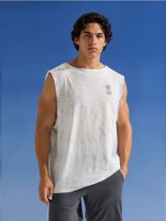 Bawełniany tank top ze wzorem tie dye - wielobarwny. T-shirty męskie Sinsay, l, bez wzorów, z bawełny, bez kołnierzyka. Za 25.99 zł.