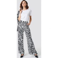 NA-KD Trend Rozszerzane spodnie z wysokim stanem - Black,White. Spodnie materiałowe damskie marki NA-KD Trend. W wyprzedaży za 64.78 zł.