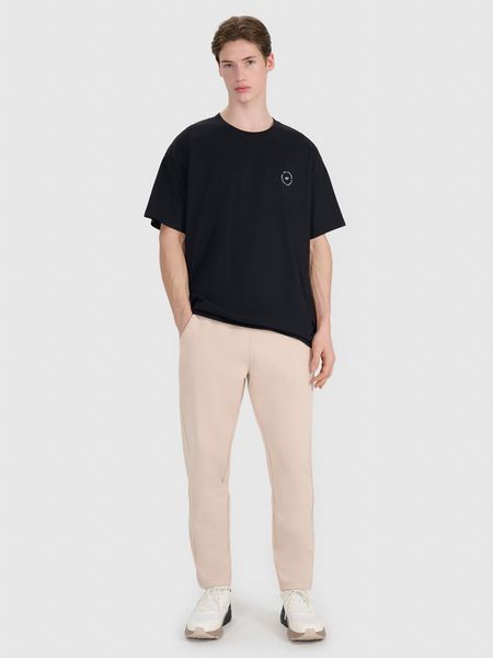 4F Spodnie dresowe męskie - beżowe M. Brązowe spodnie sportowe męskie 4f, l, bez wzorów, z bawełny. W wyprzedaży za 89.99 zł.