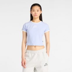 Koszulka damska New Balance WT61Y33QDYK – fioletowa. Fioletowe koszulki sportowe damskie New Balance, xs, bez wzorów, z bawełny, eleganckie, bez kołnierzyka. Za 169.99 zł.