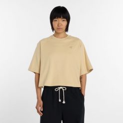 Koszulka damska New Balance WT6147DDABC – żółta. Żółte t-shirty damskie New Balance, s, z aplikacjami, z materiału, bez kołnierzyka. Za 199.99 zł.