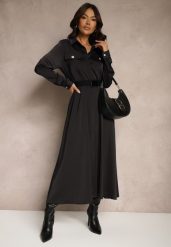 Czarna Satynowa Sukienka w Stylu Szmizjerki z Imitacjami Kieszeni i Paskiem Vaminay. Czarne sukienki damskie Renee, l, bez wzorów, z satyny, eleganckie, bez kołnierzyka, bez ramiączek, maxi, kopertowe. Za 119.99 zł.