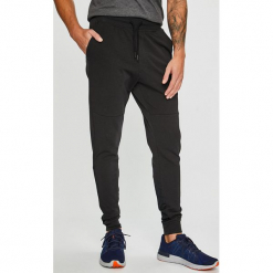 Under Armour - Spodnie Terry. Szare spodnie sportowe męskie marki Under Armour, z bawełny. Za 259.90 zł.
