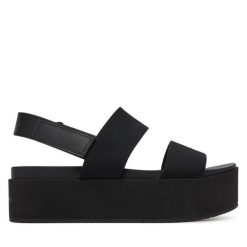 Sandały Calvin Klein Jeans. Czarne sandały damskie Calvin Klein Jeans, bez wzorów, z jeansu, bez obcasa, na koturnie, bez zapięcia. Za 239.99 zł.