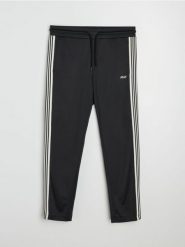 Spodnie dresowe z ozdobnymi taśmami po boku - czarny. Czarne spodnie sportowe męskie Sinsay, l, bez wzorów, z dresówki, na fitness i siłownię. Za 59.99 zł.