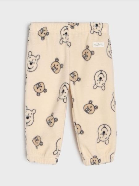 Spodnie polarowe Winnie the Pooh - beżowy. Brązowe spodenki niemowlęce Sinsay, bez wzorów, z jeansu. Za 19.99 zł.