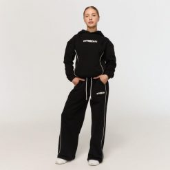 Spodnie dresowe damskie fitness oversize czarne Varsity. Czarne spodnie dresowe damskie GYMBEAM, l, bez wzorów, z dresówki. Za 139.90 zł.