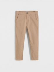 Spodnie chino slim fit - beżowy. Brązowe spodnie materiałowe męskie Reserved, bez wzorów, z bawełny. W wyprzedaży za 119.99 zł.