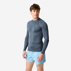 Top UV surfingowy męski Decathlon 100 długi rękaw. Niebieskie koszulki sportowe męskie Decathlon, l, bez wzorów, z elastanu, bez kołnierzyka, bez ramiączek. Za 59.99 zł.