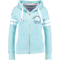 Superdry Bluza rozpinana bolt teal snowy. Bluzy damskie marki Superdry. W wyprzedaży za 350.10 zł.