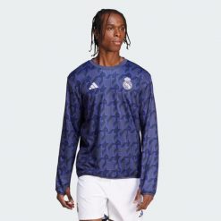 Koszulka Real Madrid Pre-Match Warm. Niebieskie koszulki sportowe męskie Adidas, l, bez wzorów, z materiału, bez kołnierzyka, bez ramiączek, do piłki nożnej. W wyprzedaży za 401.75 zł.