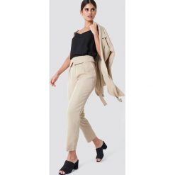 Trendyol Spodnie z wysokim stanem - Beige. Brązowe spodnie materiałowe damskie Trendyol, z lyocellu. Za 161.95 zł.
