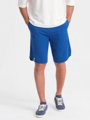 Szorty męskie dresowe z zaokrągloną nogawką - niebieskie V1. Niebieskie krótkie spodenki sportowe męskie Ombre Clothing, m, bez wzorów, z bawełny. W wyprzedaży za 39.99 zł.