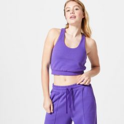 Koszulka bez rękawów damska Domyos Gym & Pilates 520 Crop. Fioletowe koszulki sportowe damskie DOMYOS, m, bez wzorów, z bawełny, bez kołnierzyka, bez ramiączek, na fitness i siłownię. Za 99.99 zł.