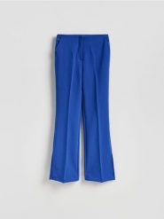 Spodnie z rozcięciami long leg - niebieski. Niebieskie spodnie materiałowe damskie Reserved, l, bez wzorów, z tkaniny. Za 129.99 zł.