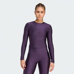 Koszulka Workout Essentials Long-Sleeve Shine. Fioletowe koszulki sportowe damskie Adidas, bez wzorów, bez kołnierzyka, bez ramiączek, na fitness i siłownię. Za 219.00 zł.