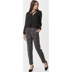 Czarno-Czerwone Spodnie Gaia. Czarne spodnie materiałowe damskie Born2be, l, bez wzorów, z materiału. Za 59.99 zł.