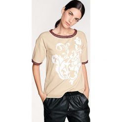 Koszulka w kolorze piaskowym. T-shirty damskie marki Heine. W wyprzedaży za 108.95 zł.