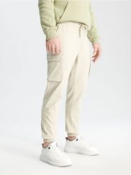 Spodnie jogger - beżowy. Brązowe spodnie materiałowe męskie Sinsay, m, bez wzorów, z bawełny. Za 59.99 zł.