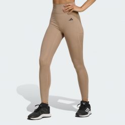 Legginsy 7/8 bez szwu z przodu Optime Essentials. Brązowe legginsy damskie Adidas, xl, bez wzorów. W wyprzedaży za 142.35 zł.