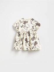 Sukienka Minnie Mouse - złamana biel. Sukienki niemowlęce Reserved, bez wzorów, z bawełny, bez ramiączek. Za 45.99 zł.