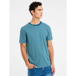 Koszulka Protest Prtgodna. Niebieskie koszulki sportowe męskie Protest, na lato, bez wzorów, z bawełny, bez kołnierzyka, bez ramiączek, trekkingowe. Za 189.99 zł.