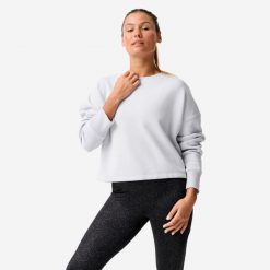 Bluza damska Domyos Gym & Pilates crop. Niebieskie bluzy sportowe damskie DOMYOS, xs, bez wzorów, z bawełny, bez kaptura, na jogę i pilates. Za 89.99 zł.