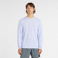 Koszulka męska New Balance MT51802DYK – niebieska. Niebieskie bluzki z długim rękawem męskie New Balance, m, bez wzorów, z materiału, klasyczne, bez kołnierzyka. Za 129.99 zł.