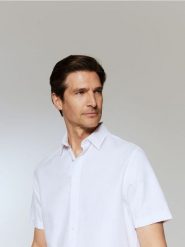 Elegancka koszula regular fit - biały. Białe koszule męskie Reserved, l, bez wzorów, z bawełny, eleganckie, bez kołnierzyka, bez ramiączek. Za 99.99 zł.