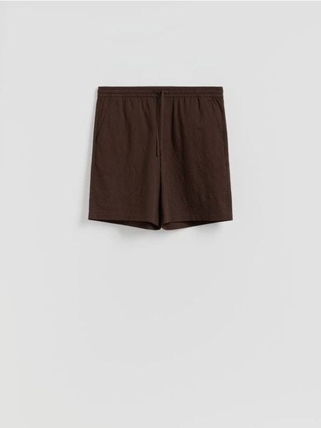 Szorty loose fit - ciemnobrązowy. Brązowe szorty męskie Reserved, l, bez wzorów, z tkaniny. Za 119.99 zł.