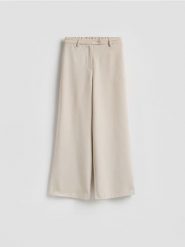 Spodnie z szerokimi nogawkami - beżowy. Brązowe spodnie materiałowe damskie Reserved, l, bez wzorów, z tkaniny. Za 99.99 zł.