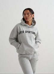 Damska bluza z kapturem, drapany polar, luźny Varsity Sweat Hood szary melanż. Szare bluzy damskie Aim'n, l, bez wzorów, z bawełny, z kapturem, na fitness i siłownię. Za 339.00 zł.