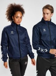 Kurtka ortalionowa piłkarska dla dorosłych Hummel Core XK Spray Jacket. Niebieskie kurtki damskie Hummel, m, bez wzorów, z materiału, z kapturem. Za 147.00 zł.