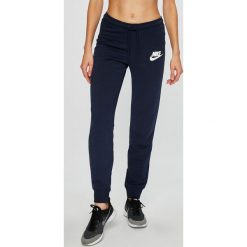 Nike Sportswear - Spodnie. Szare spodnie sportowe damskie Nike Sportswear, z bawełny. W wyprzedaży za 179.90 zł.