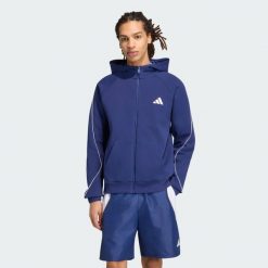 BLUZA STADIUM Z KAPTUREM, MAŁYM LOGO I SUWAKIEM NA CAŁEJ DŁUGOŚCI. Niebieskie bluzy sportowe męskie Adidas, s, bez wzorów, z bawełny, z kapturem. Za 329.00 zł.