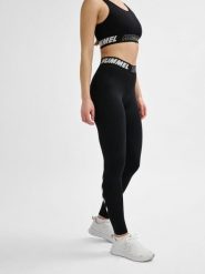 Damskie bawełniane legginsy o średnim kroju Hummel TE Maja. Czarne legginsy sportowe damskie Hummel, xs, bez wzorów, z bawełny, z standardowym stanem, na fitness i siłownię. Za 161.50 zł.