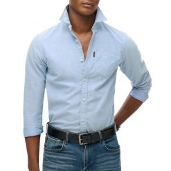 Wyblakana koszula Superdry Oxford. Niebieskie koszule męskie Superdry., xl, bez wzorów, z bawełny, casualowe, bez kołnierzyka, bez ramiączek. Za 311.10 zł.
