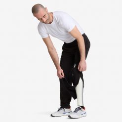 Spodnie męskie rozpinane Decathlon. Czarne spodnie sportowe męskie Decathlon, m, bez wzorów, z bawełny. Za 129.99 zł.