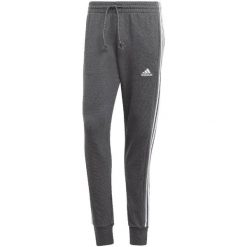 Spodnie męskie adidas Essentials French Terry Tapered Cuff 3-Stripes. Białe spodnie sportowe męskie Adidas, m, bez wzorów. W wyprzedaży za 200.65 zł.