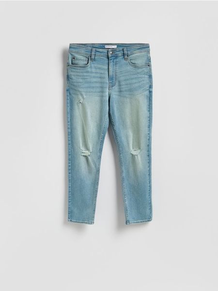 Jeansy carrot slim z przetarciami - indigo jeans. Niebieskie jeansy męskie Reserved. Za 139.99 zł.