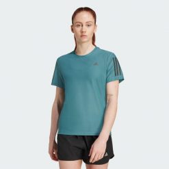 Koszulka Own The Run. Niebieskie koszulki sportowe damskie Adidas, l, bez wzorów, z materiału, bez kołnierzyka, bez ramiączek, do biegania. Za 149.00 zł.