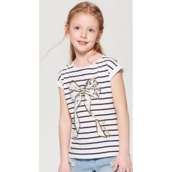 Koszulka z cekinową aplikacją dla dziewczynki little princess - Biały. T-shirty damskie marki Mohito. W wyprzedaży za 19.99 zł.