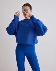 Damska bluza biegowa oddychająca, odprowadzająca wilgoć Le Run błękitna. Niebieskie bluzy damskie Aim'n, l, bez wzorów, z bawełny, bez kaptura. Za 381.00 zł.