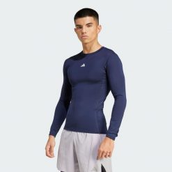 Koszulka TECHFIT Compression Training Long Sleeve. Niebieskie buty sportowe męskie Adidas, bez wzorów, z materiału, bez kołnierzyka, bez ramiączek, na fitness i siłownię, techfit (adidas). Za 179.00 zł.