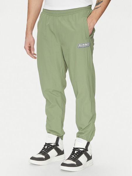 Karl Kani Joggery Essentia 60060039 Zielony Regular Fit. Zielone spodnie materiałowe męskie Karl Kani, m, bez wzorów, z syntetyku. Za 159.99 zł.