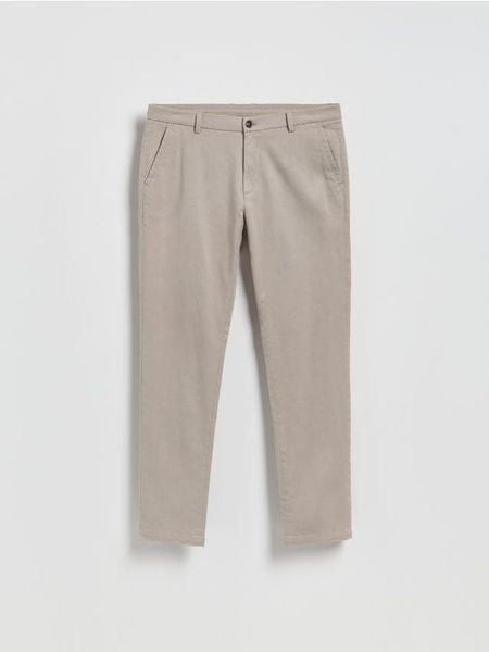 Spodnie chino slim - brązowy. Brązowe spodnie materiałowe męskie Reserved, bez wzorów, z bawełny. Za 159.99 zł.